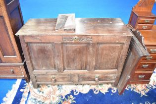 An 18th century and later oak three panelled kist, monogrammed H W, dated 1724, with double drawer