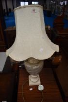 A vintage table lamp having marble style body.