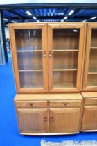 An Ercol lounge display having cupboard base, dimensions approx H162 D43 W91