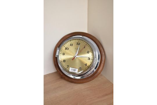 A Weimar, Quartz chrome bulkhead clock with numbered dial, chrome hands and red seconds hand,