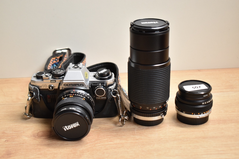 An Olympus OM10 camera with Itorex 1:2,8 28mm, an Itorex MC Auto Zoom 1:4,5 80-205, an Olympus OM-