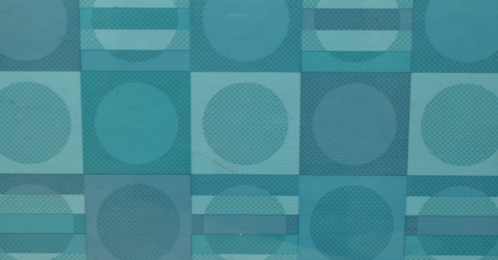 A mid-20th Century textile design, featuring a geometric arrangement of circles and patterns in