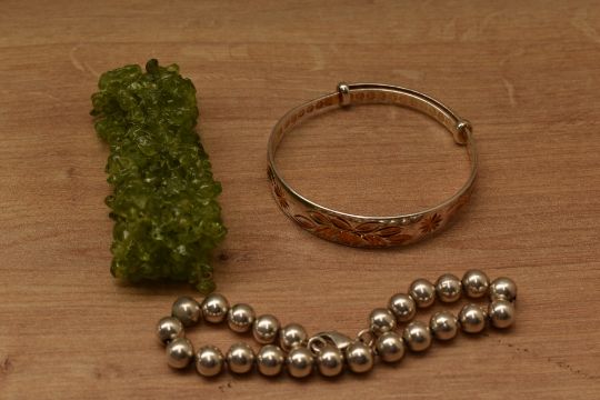 A selection of bracelets comprising a silver beaded example, a Chinese style expanding bracelet with