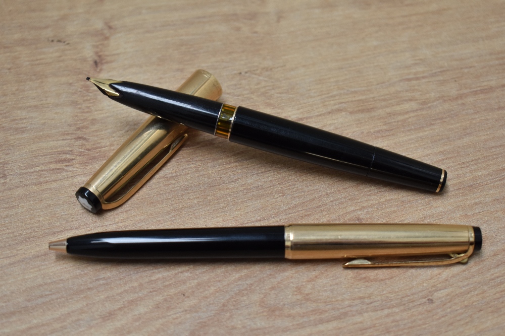 A Montblanc Meisterstuck 72 piston fill fountain pen and ballpoint pen in black having rolled gold