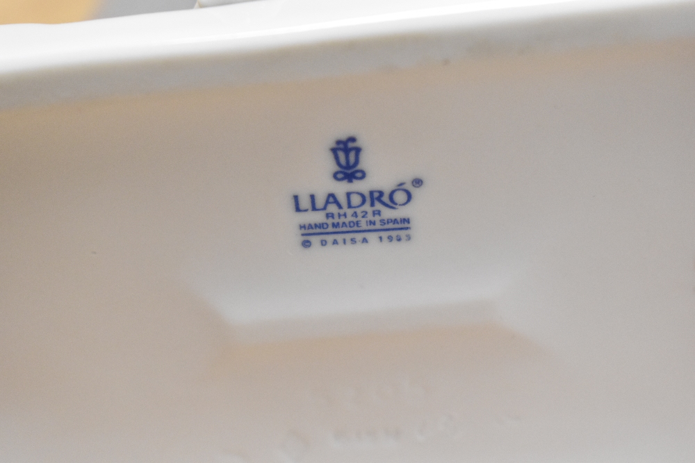 A Lladro porcelain figure 'Lamplighter' number 5205, modelled as a windswept gentleman lighting a - Image 2 of 2