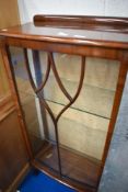 A mid 20th Century walnut china cabinet