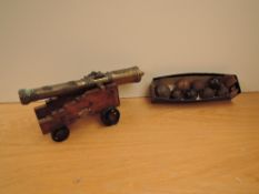 A reproduction Desk Cannon, length of barrel 32cm along with seven small cannon balls approx 4cm