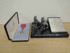 A Commemorative Trophy having rectangular black marble base with two seated Alsatian Dogs, both