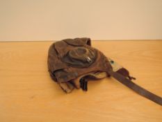 A WWII Leather Flying Helmet, marked Crown and A/M, numbers unreadable