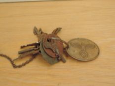 A German Gestapo Warrant Disc numbered 7597 on a key ring with two British Military Dog Tags and a