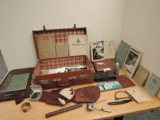 A leather case containing a collection of Military items including loose Military Photographs and