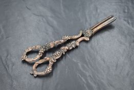 A pair of 19th century white metal grape scissors, having handles depicting grape vines, maker