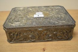 An attractive white metal jewellery box, of canted rectangular form and moulded with foliate scrolls