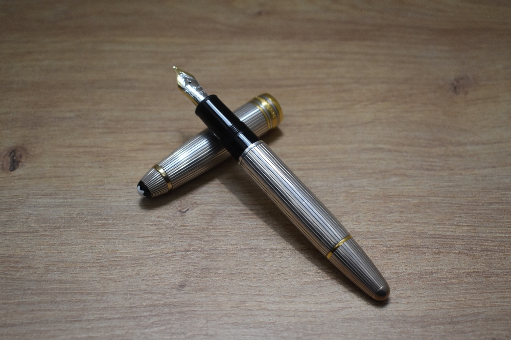 A Montblanc Meisterstuck piston fill fountain pen and propelling pencil in 925 silver with gold trim - Image 2 of 5