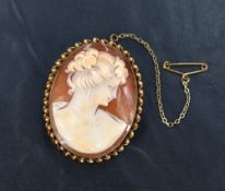 A conche shell cameo brooch depicting a maiden in profile in a 9ct gold mount, approx 45mm x