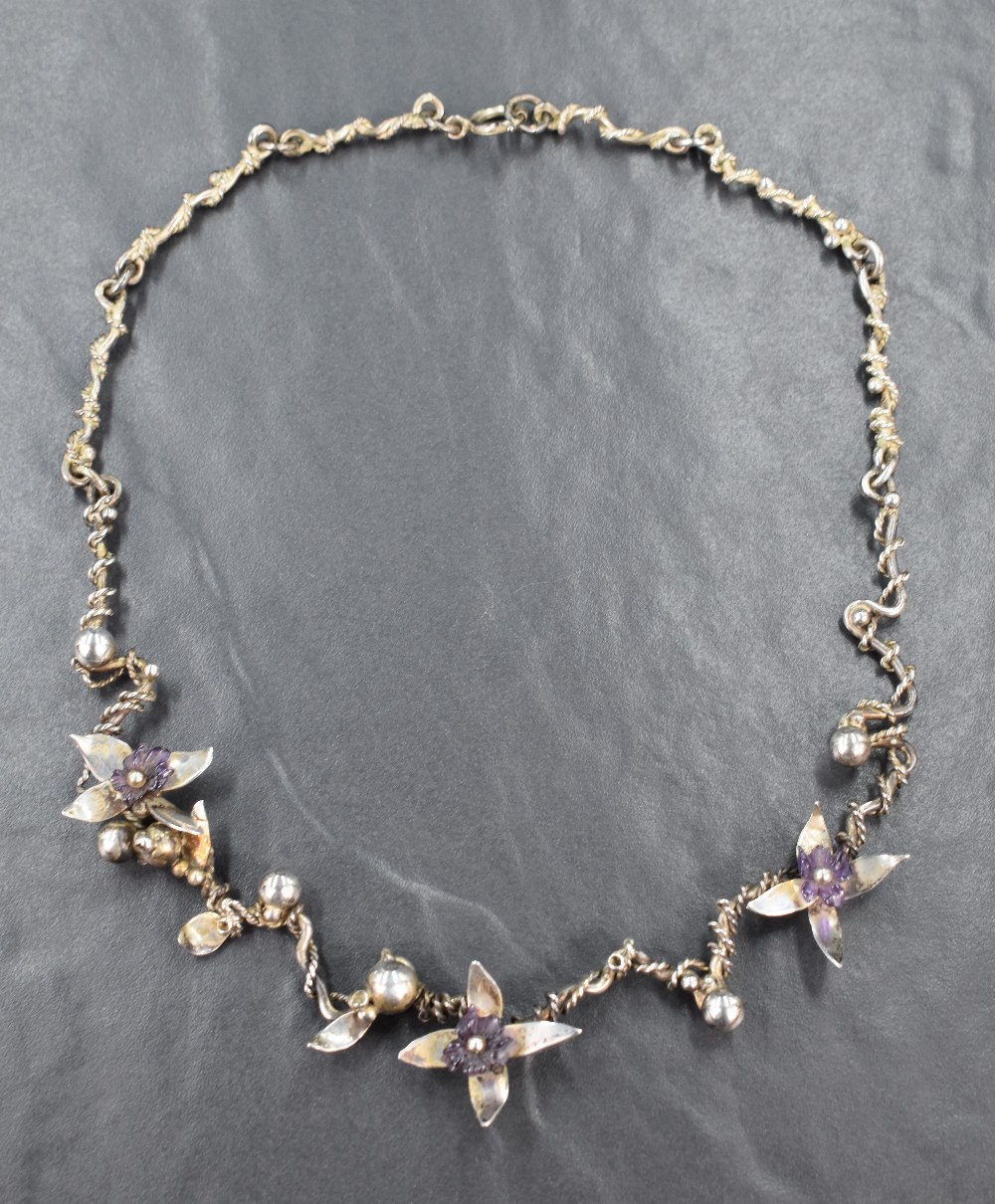 A 1970's Artisan style silver necklace having Amethyst and silver flowers on a fixed silver wire and