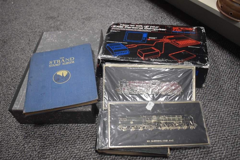 Two first day cover stamp albums sold alongside a folder of mixed loose stamps etc.