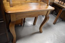 A Continental walnut side table, the moulded rectangular top over pronounced square section cabriole