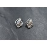 A pair of 9ct white gold clip earrings swirl wire decoration, approx 2.7g