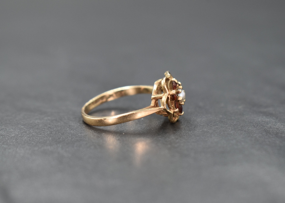 A 9ct gold garnet and seed pearl cluster ring in an open frilled mount, damage to pearl and loop - Image 2 of 3
