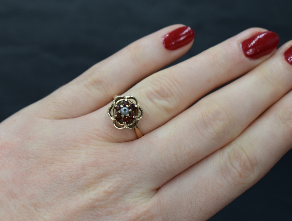 A 9ct gold garnet and seed pearl cluster ring in an open frilled mount, damage to pearl and loop - Image 3 of 3