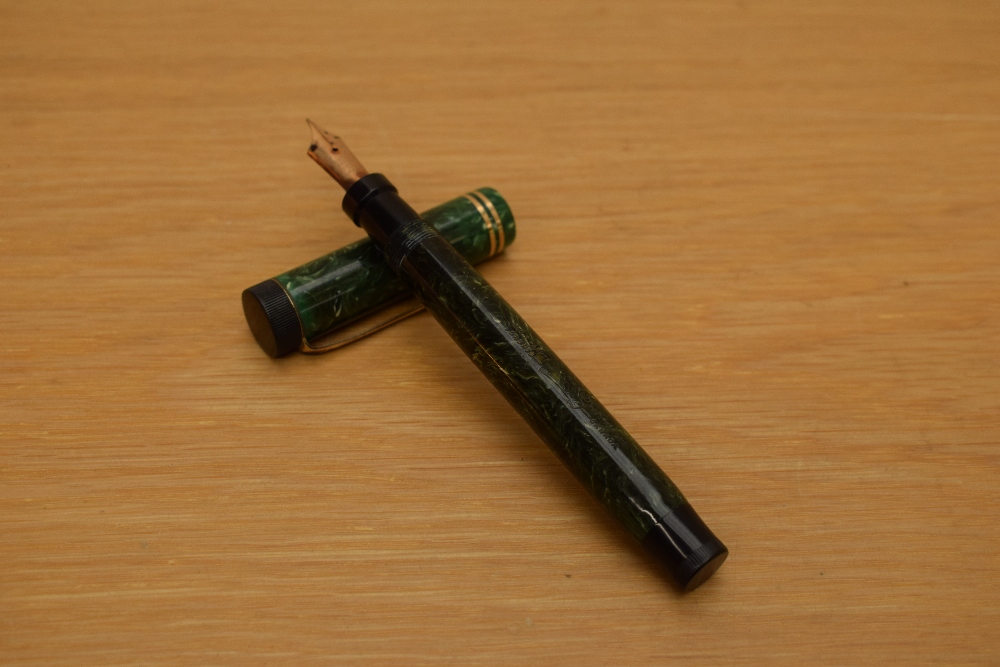 A Parker Duofold Special button fill fountain pen in jade green with two gold bands to the cap