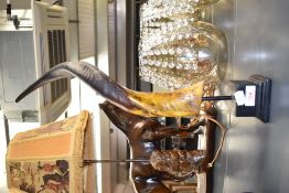 A replica Goat or Antelope twisted horn sculpture supported on resin base, h52cm.