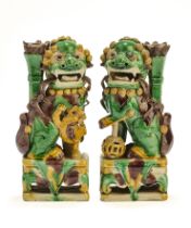 A PAIR OF CHINESE BISCUIT BUDDHIST LION INCENCE HOLDERS, QING DYNASTY, KANGXI PERIOD (1662-1722)