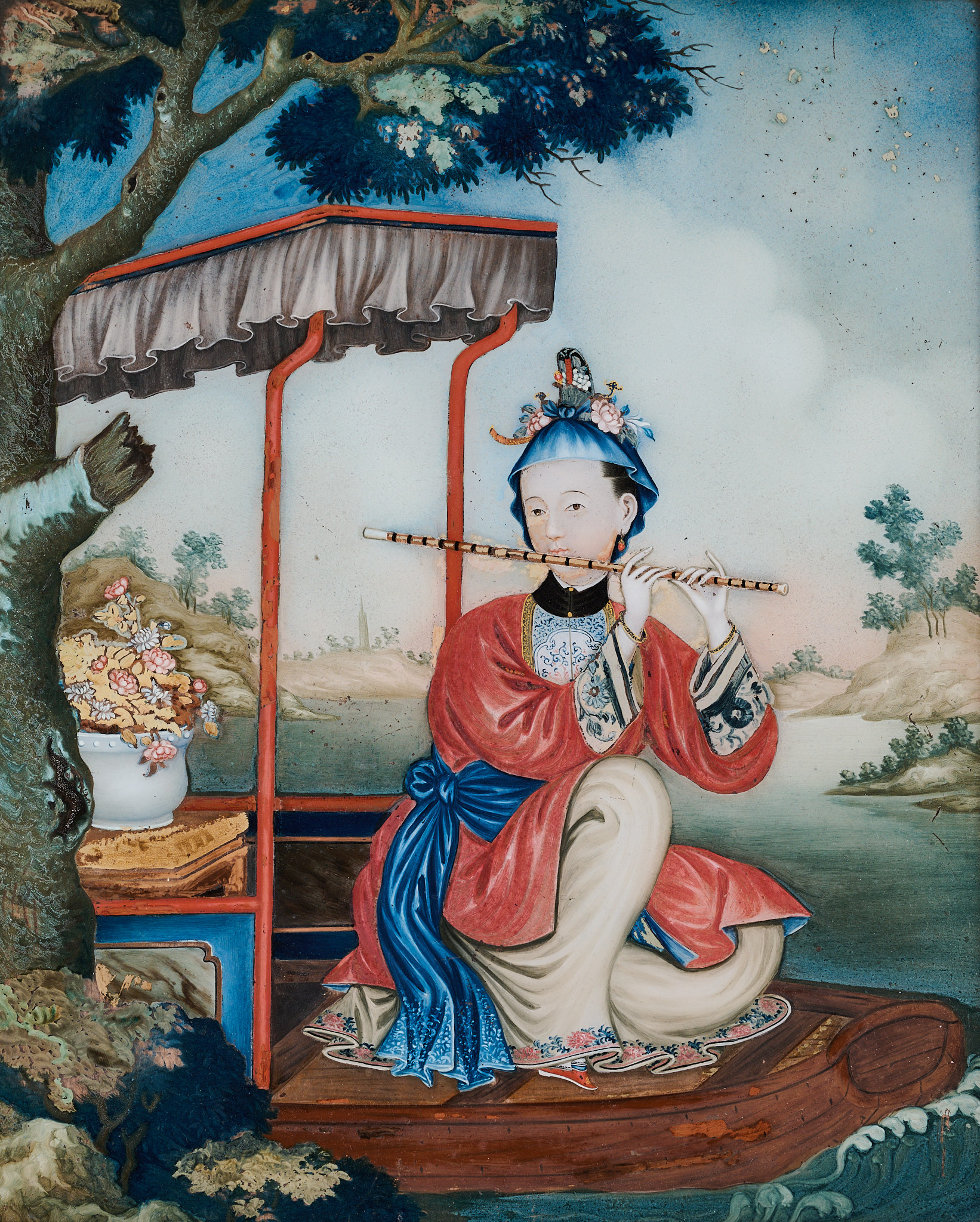 A CHINESE EXPORT REVERSE GLASS PAINTING OF A MAIDEN PLAYING A FLUTE, QING DYNASTY, 18TH CENTURY