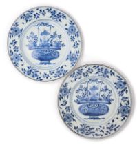 A PAIR OF CHINESE BLUE AND WHITE 'FLOWER BASKET' PLATES, QING DYNASTY, KANGXI PERIOD (1662-1722)