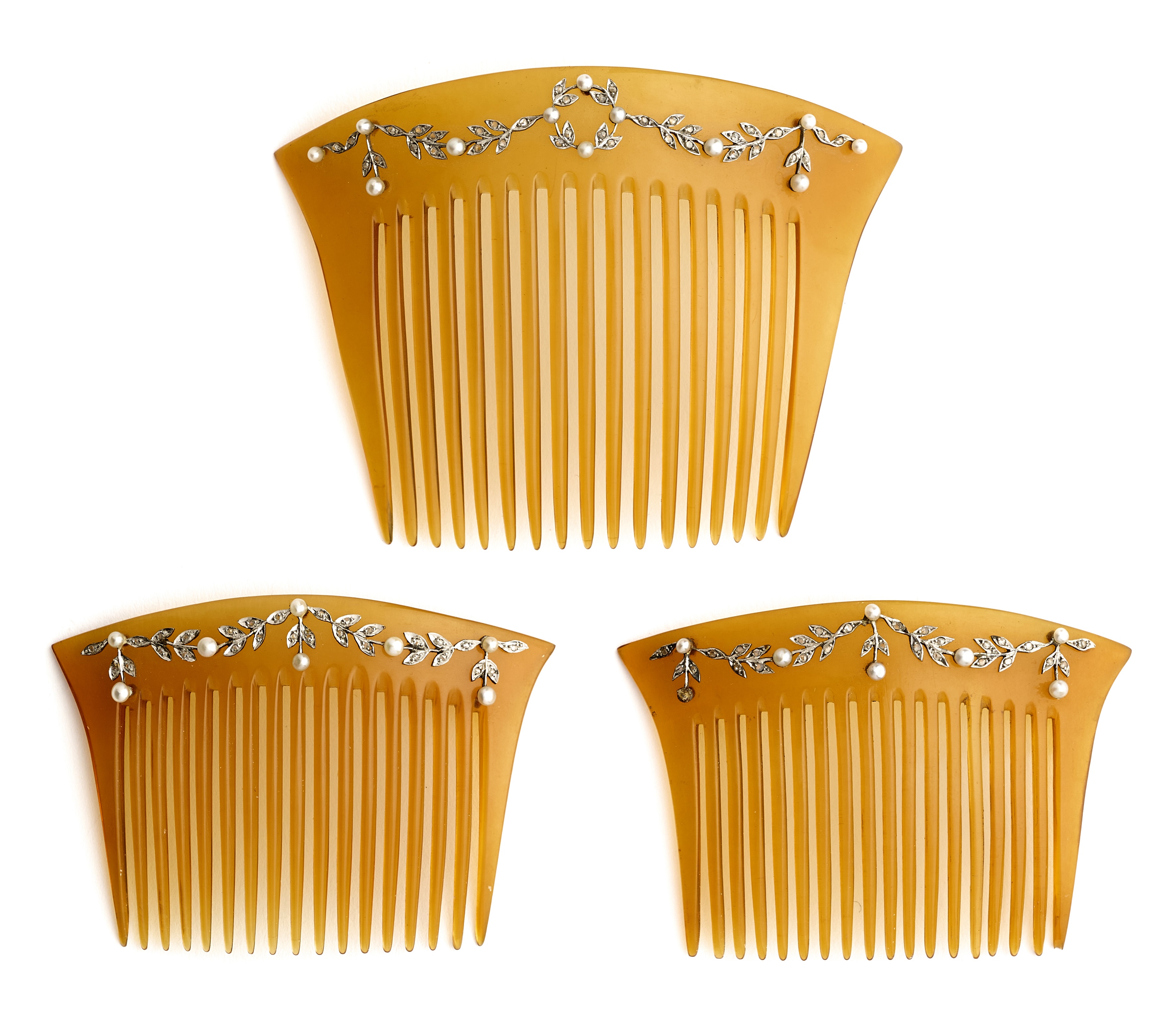 ˜ A SET OF THREE BELLE EPOQUE TORTOISESHELL, DIAMOND AND SEED PEARL HAIR COMBS, CIRCA 1910