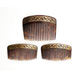 ˜ □ A SET OF THREE EDWARDIAN TORTOISESHELL AND GOLD HAIR COMBS, 1900s