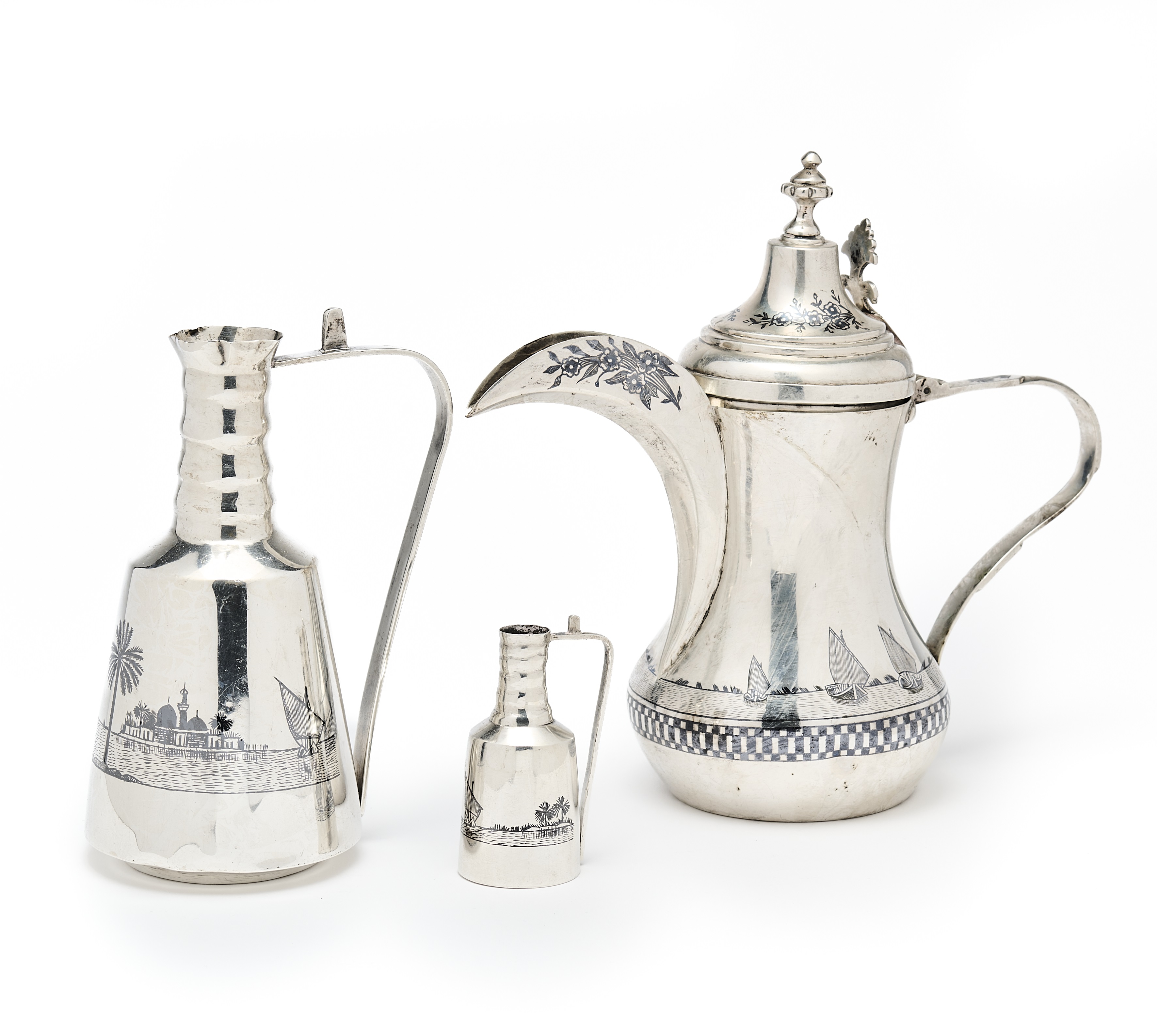 AN IRAQI COFFEE POT AND PAIR OF JUGS IN SIZES, PROBABLY BASRA OR OMARA, MID 20TH CENTURY