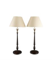 A PAIR OF SLENDER TURNED STAINED WOOD TABLE LAMPS, the facetted tapering columns raised on