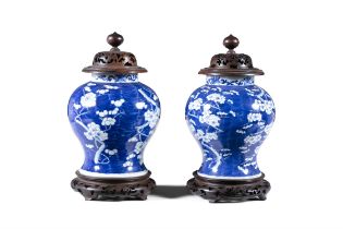 A PAIR OF 19TH CENTURY CHINESE BLUE AND WHITE REVERSE DECORATED BALUSTER VASES, with timber