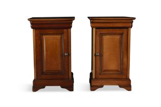 A PAIR OF MAHOGANY BEDSIDE CABINETS, each with panelled door, raised on bracket feet. 65cm high,