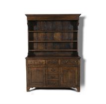 A 19TH CENTURY OAK WELSH DRESSER with raised shelf, above three drawers and cupboard base. 208.