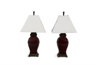 A PAIR OF 20TH CENTURY RED GLAZED TABLE LAMPS, of square baluster form, outstepped brass