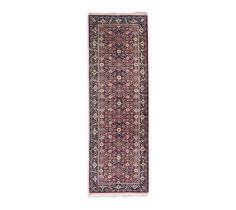 A SEMI-ANTIQUE TURKISH WOOL RUNNER, 250 x 78.5cm the central field filled with small flower