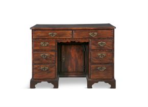 A GEORGE III MAHOGANY KNEE-HOLE DESK the moulded rectangular top with inverted corners,