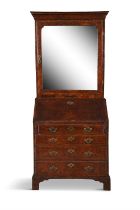 A GEORGE II WALNUT SLOPEFRONT BUREAU the moulded cavetto cornice above a single mirrored door