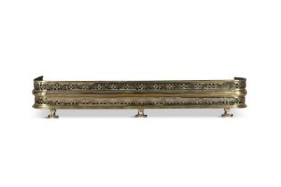 A PIERCED BRASS CURB FENDER, 19TH CENTURY with rounded corners and lyre decorated frieze,