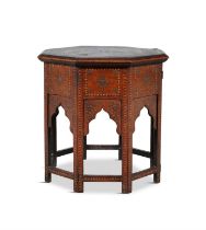 AN INDIAN HARDWOOD AND BRASS INLAID OCTAGONAL TABLE C.1900 profusely decorated with leaf scrolls