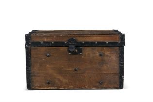 AN EDWARDIAN STRAPWORK BOUND TRAVEL TRUNK with twin carrying handles, applied with strapwork