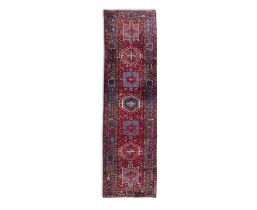 A HERIZ WOOL RUNNER, N.W. IRAN. 335 x 92CM the central frieze woven with seven alternating