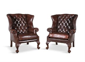 A PAIR OF RED WINGBACK UPHOLSTERED ARMCHAIRS 20TH CENTURY covered in a button back hide,