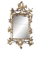 A GILTWOOD ROCOCO STYLE MIRROR the rectangular glass plate enclosed within a pierced scrollwork