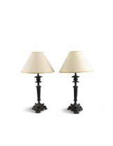 A PAIR OF REGENCY STYLE BRONZED METAL COLUMN TABLE LAMPS, raised on a triangular base,