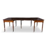 AN IRISH GEORGE IV MAHOGANY EXTENDING DINING TABLE, the figured rectangular top with rounded