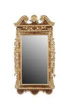 A GEORGIAN STYLE WALNUT AND PARCEL GILT MIRROR, 20TH CENTURY fitted with a plain rectangular